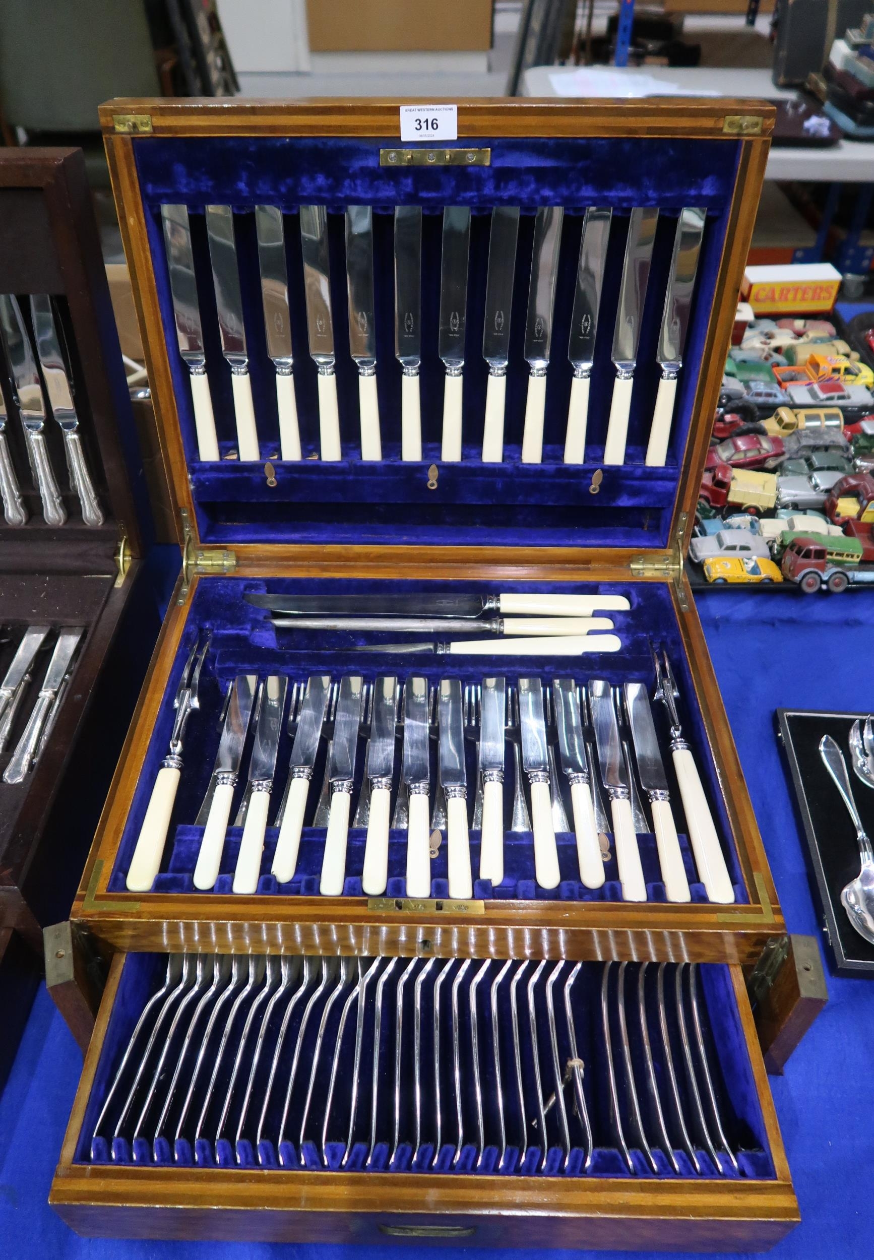 A Two Drawer Canteen Of Stainless Steel Ivorine Handled Cutlery By