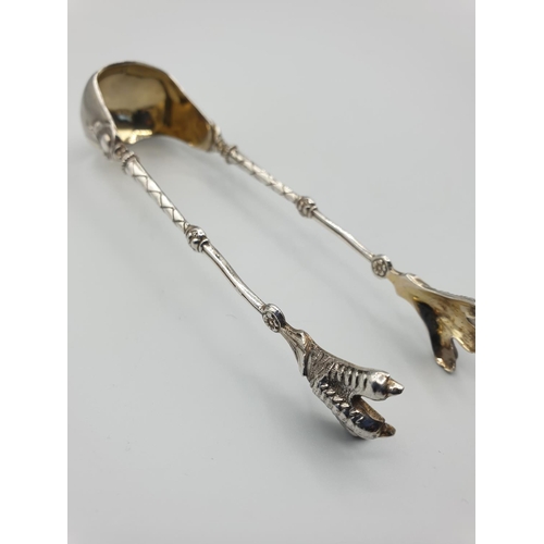 11 - Ornate pair of continental silver tongs with grips in the shape of claws, full set of markings stamp... 