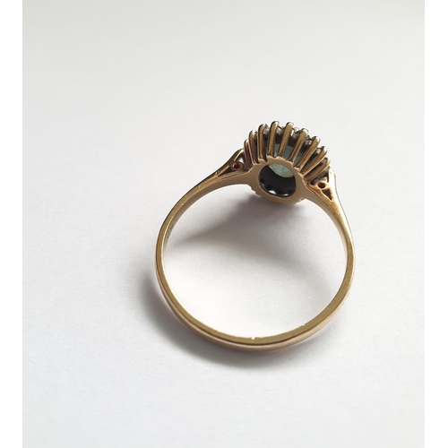 32 - Hallmarked 9ct gold ring with centre sapphire and a diamond surround, oval shape , approx 3g size T.