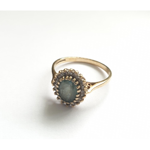 32 - Hallmarked 9ct gold ring with centre sapphire and a diamond surround, oval shape , approx 3g size T.