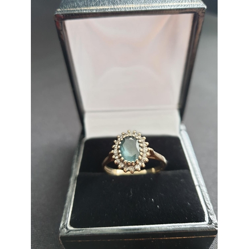 32 - Hallmarked 9ct gold ring with centre sapphire and a diamond surround, oval shape , approx 3g size T.