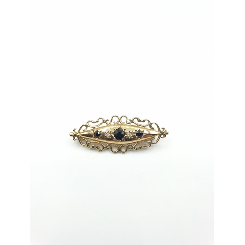 55 - 9ct gold boat shaped brooch consisting of a centre sapphire and a smaller sapphire and diamond eithe... 