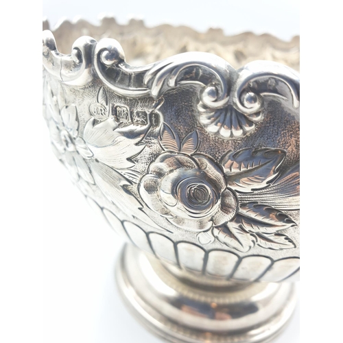 1 - A silver fruit bowl 1901 by J.Round of Sheffield with floral repousse work under a scrolled edge in ... 