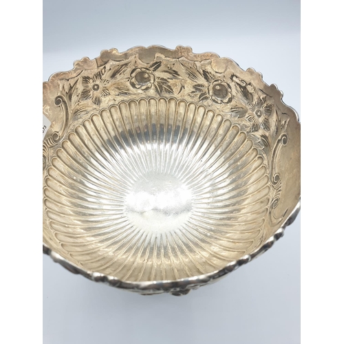 1 - A silver fruit bowl 1901 by J.Round of Sheffield with floral repousse work under a scrolled edge in ... 