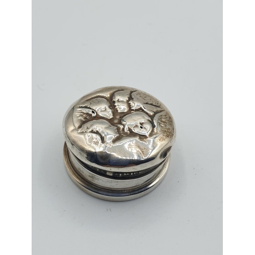 261 - Unusual small silver round pill box with faces on the lid