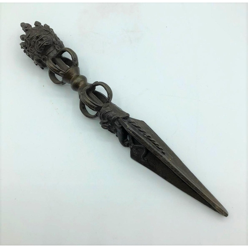 252 - Antique Oriental ceremonial dagger. 3 faces on hilt 10.9oz. 23cms in length