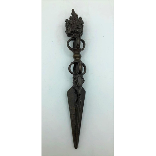 252 - Antique Oriental ceremonial dagger. 3 faces on hilt 10.9oz. 23cms in length