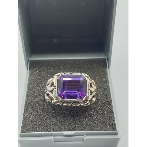 293 - Vintage silver ring with large rectangular purple/blue stone. Alexandrite type colour. Ornate silver... 