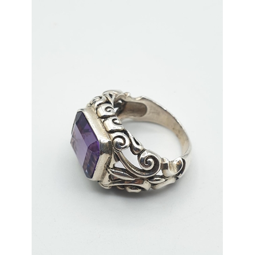 293 - Vintage silver ring with large rectangular purple/blue stone. Alexandrite type colour. Ornate silver... 