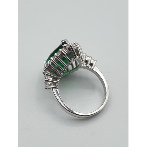 299 - Stone set silver ring. Having a pear shaped emerald green centre stone with a zirconia surround. Zir... 