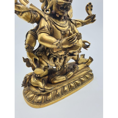 27 - A very early gilded bronze figure of an Oriental dragon god, 19cm tall and weight 1700g.
Gilding is ... 