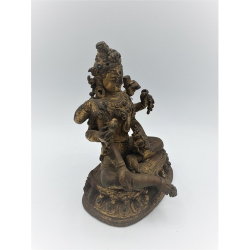 29 - A very early gilded bronze figure of an Oriental 6 arm Goddess, 14cm tall and weighing 1139g.