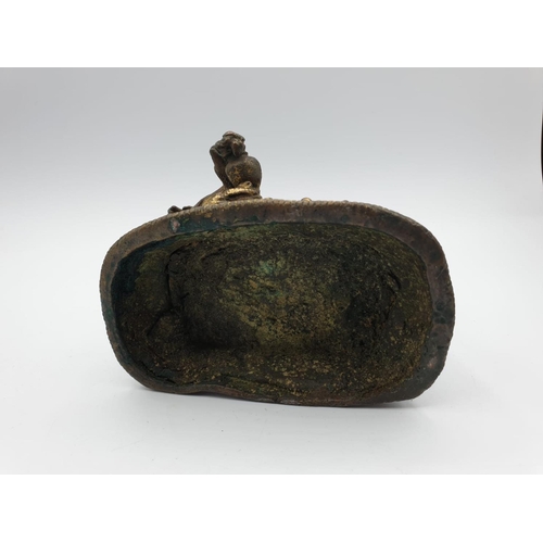 29 - A very early gilded bronze figure of an Oriental 6 arm Goddess, 14cm tall and weighing 1139g.