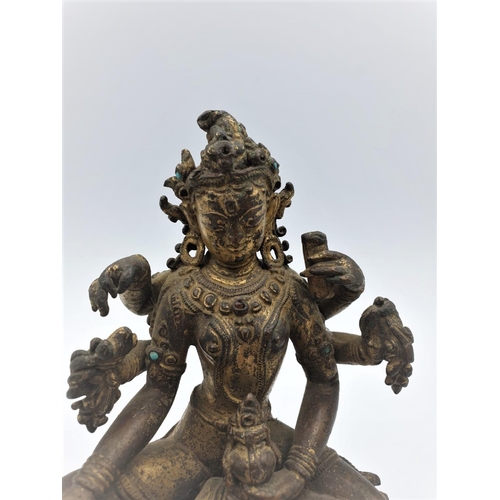 29 - A very early gilded bronze figure of an Oriental 6 arm Goddess, 14cm tall and weighing 1139g.