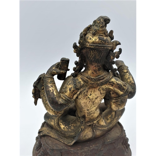 29 - A very early gilded bronze figure of an Oriental 6 arm Goddess, 14cm tall and weighing 1139g.