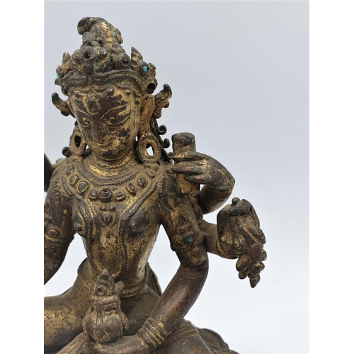 29 - A very early gilded bronze figure of an Oriental 6 arm Goddess, 14cm tall and weighing 1139g.