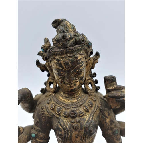 29 - A very early gilded bronze figure of an Oriental 6 arm Goddess, 14cm tall and weighing 1139g.