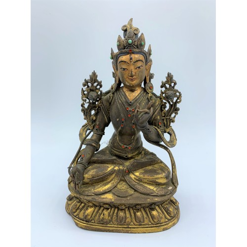 A very early Tibetan religious deity,gilt on bronze with turquoise stones and painted face, weight 1.26kg.