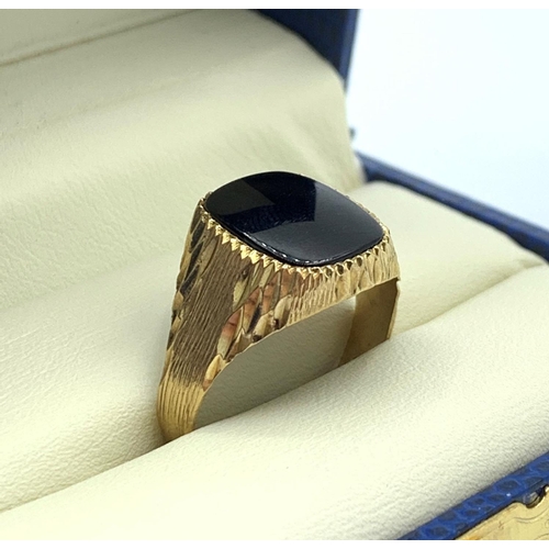 65 - 9CT Yellow Gold Gent Ring with square black stone centre, size Q and weight 3.2g approx