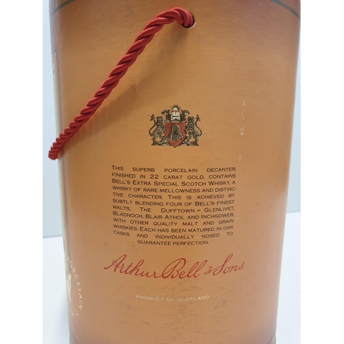 199 - Bells Scotch Whisky Decanter by WADE in original cylindrical carton , 22x16cm