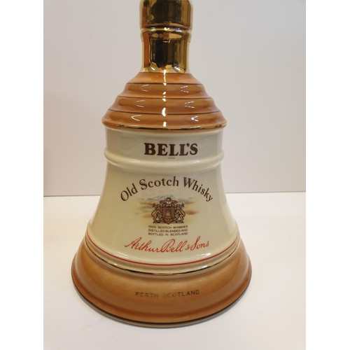 199 - Bells Scotch Whisky Decanter by WADE in original cylindrical carton , 22x16cm