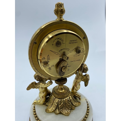 28 - Vintage 8 Day Swiza Clock with alarm on a marble base supported by 2 Cherubs, 14cm tall and weight 7... 