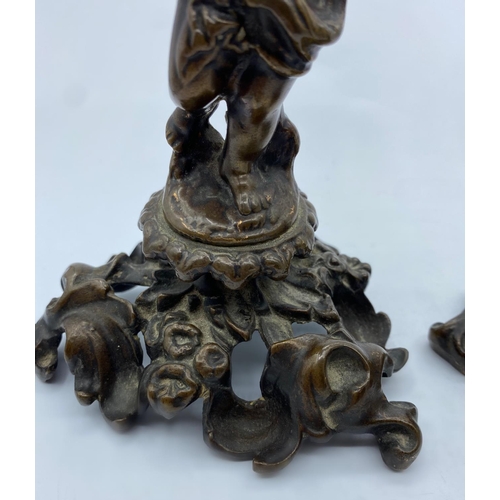 95 - A Pair of Antique Bronze Candlesticks with Cherubs, weight 2.9kg and 26cm tall (2)