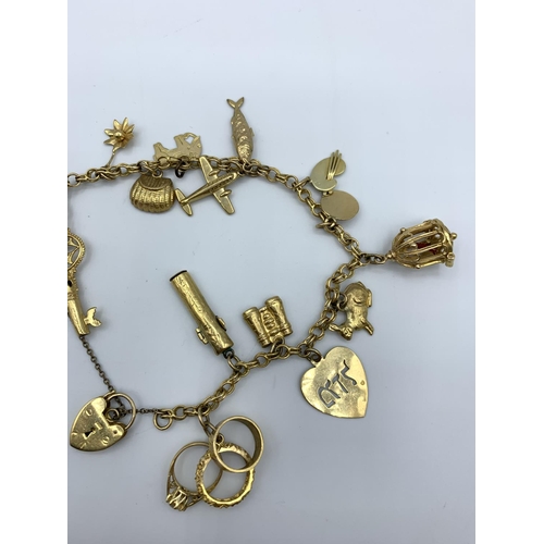 292 - A 9ct yellow Gold Charm Bracelet with 15 interesting charms, weighing 29.9g.