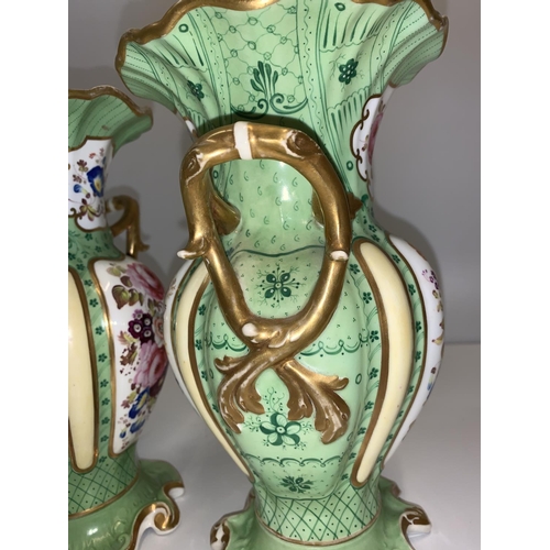 336 - Pair of Rococo style handled Urns in green with floral design to front and rear panels, 24cm tall (2... 