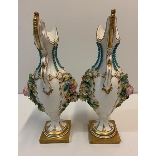 349 - Pair of Baroque ornate Vases with handles on a gold base, 28cm tall with raised flower to both sides... 