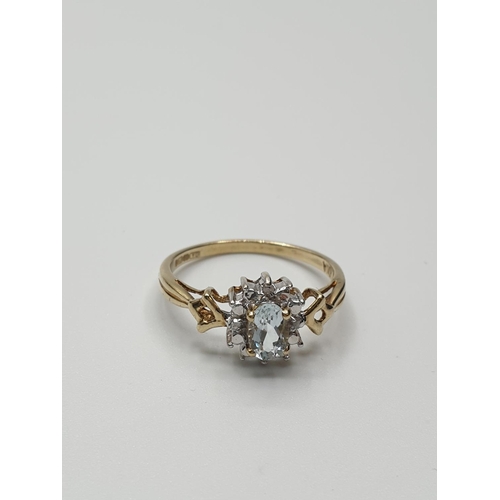 18 - Stone set 9ct Yellow gold Ring having an oval Topaz to centre of mount with a surround of small Diam... 