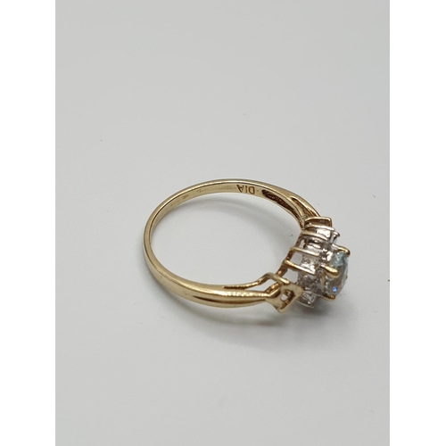 18 - Stone set 9ct Yellow gold Ring having an oval Topaz to centre of mount with a surround of small Diam... 