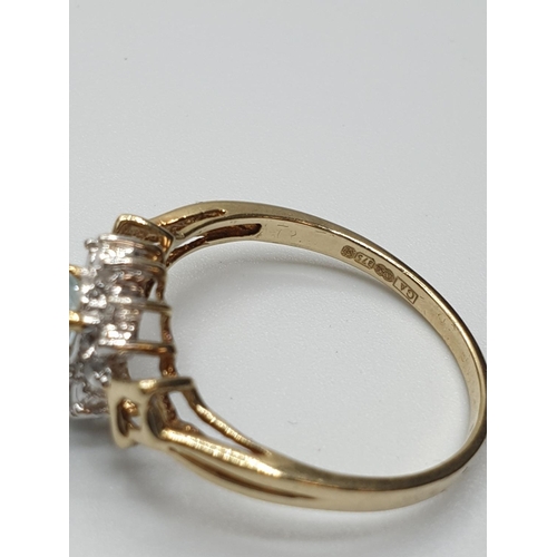 18 - Stone set 9ct Yellow gold Ring having an oval Topaz to centre of mount with a surround of small Diam... 