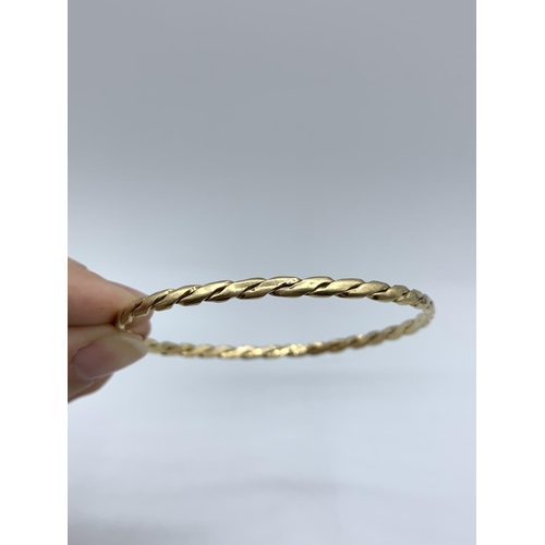 148 - A yellow metal (tested as 9ct gold) twisted Bangle, weight 9.5g approx