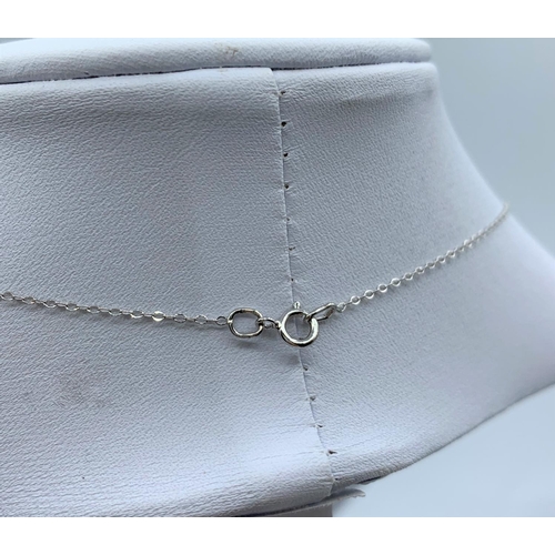 154 - 9K White Gold Chain with a Blue Stone Pendant, weight 1.4g and 44cm long chain