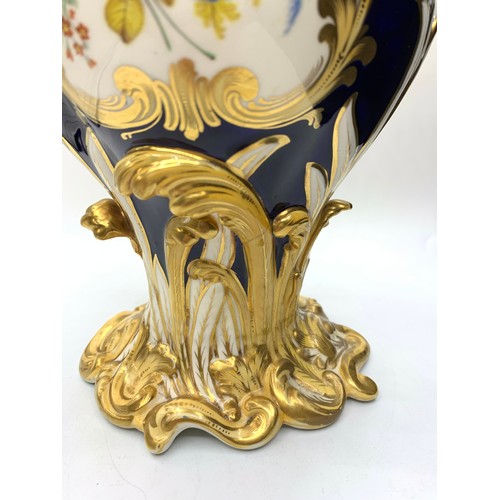 3 - A pair of H&R Daniel Baroque Vases glazed blue with gilded handles and laurels, slight hairline crac... 