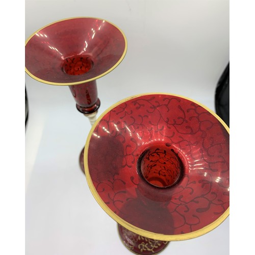 146 - A pair of Blown Cranberry Glass Candlesticks with glass and gold stems, 25cm tall (2)