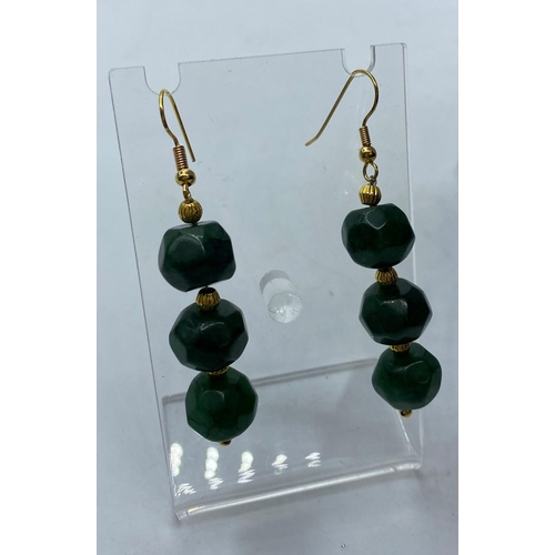 105 - A Necklace and matching Earrings of large, faceted, dark green Jade beads, with large Chinese dragon... 