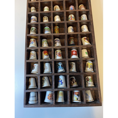 463 - Assortment of 50x Bone China Thimbles presented in a wooden display case, each thimble has a differe... 