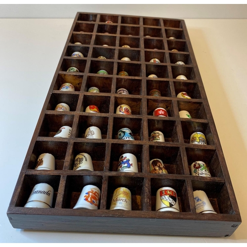 463 - Assortment of 50x Bone China Thimbles presented in a wooden display case, each thimble has a differe... 