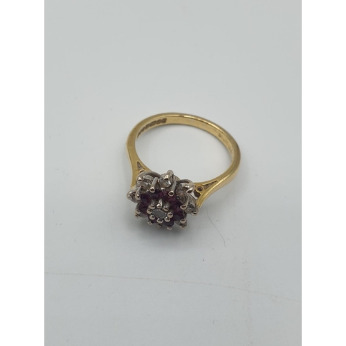 217 - Stone set 18ct Gold Ring with Diamonds ,with an inner ring of rubies, additional diamond to centre, ... 