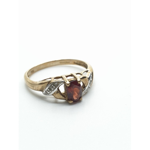 119 - 9CT Gold Ring with Diamond Encrusted shoulders and Garnet Centre Stone, weight 1.8g and size N/O