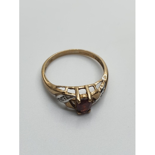 119 - 9CT Gold Ring with Diamond Encrusted shoulders and Garnet Centre Stone, weight 1.8g and size N/O