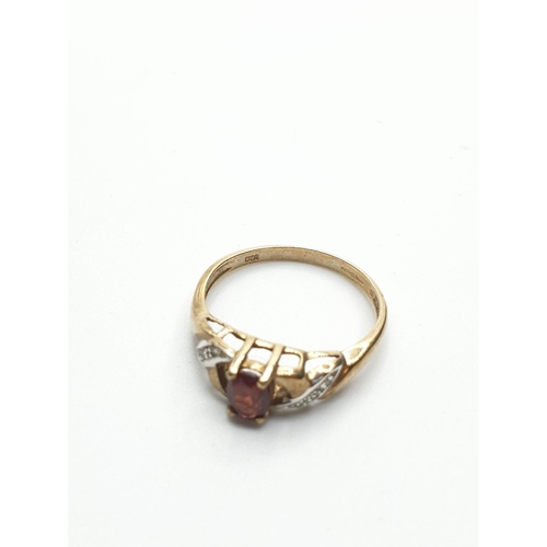 119 - 9CT Gold Ring with Diamond Encrusted shoulders and Garnet Centre Stone, weight 1.8g and size N/O