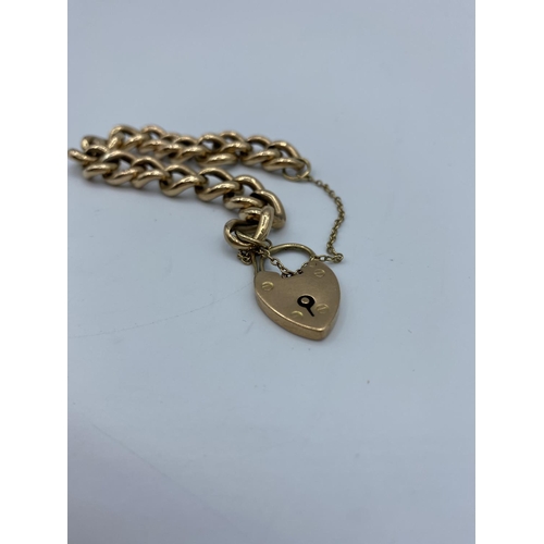 387 - 9ct Gold chunky link Bracelet with heart padlock, and safety chain weight 15.58g approx .