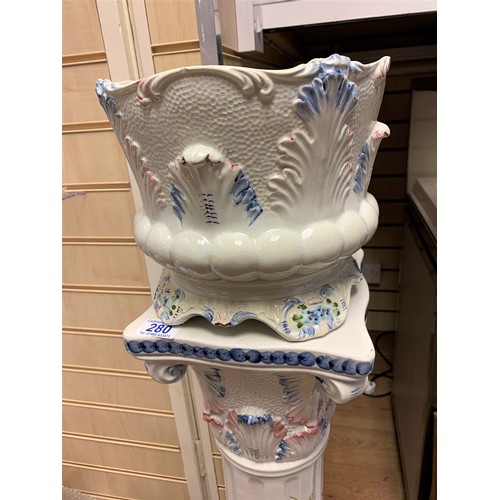 280 - A Porcelain Jardiniere on a classic column plynth in white with floral decoration