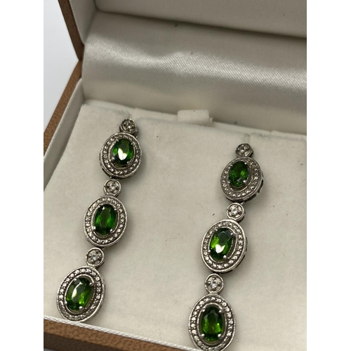 211 - Pair of Stone set Silver Drop earrings, each earring having three green Russian diopside stones in o... 