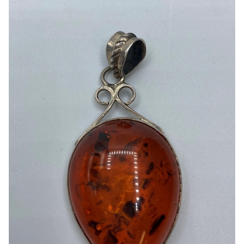 212 - Silver and Amber set Pendant, having a sizeable piece of pear shaped Baltic Amber in a silver mount ... 