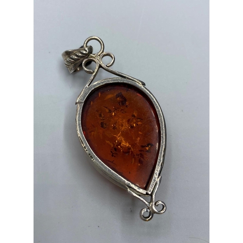 212 - Silver and Amber set Pendant, having a sizeable piece of pear shaped Baltic Amber in a silver mount ... 