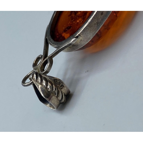 212 - Silver and Amber set Pendant, having a sizeable piece of pear shaped Baltic Amber in a silver mount ... 